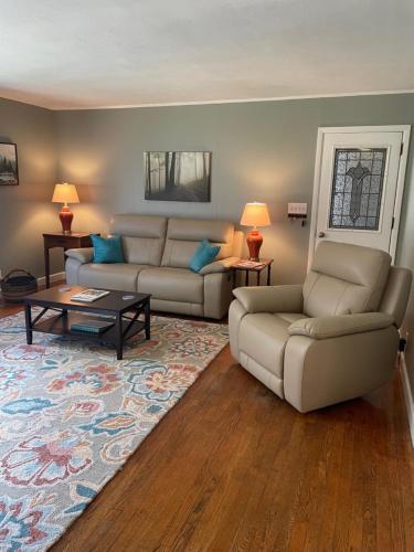 a living room with two couches and a coffee table at The Hideaway in Downtown Brevard in Brevard