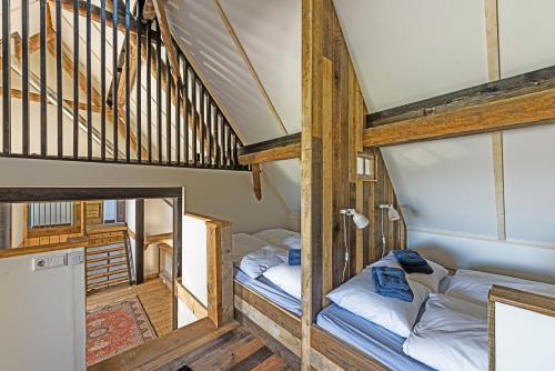 two bunk beds in a room with a staircase at TopLocatiezeeland # Sea Barn in Oostkapelle