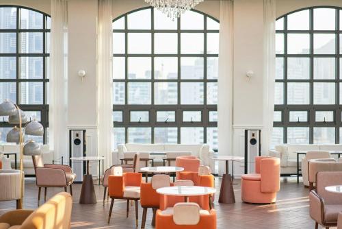 a room with tables and chairs and large windows at Space and Mood in Busan
