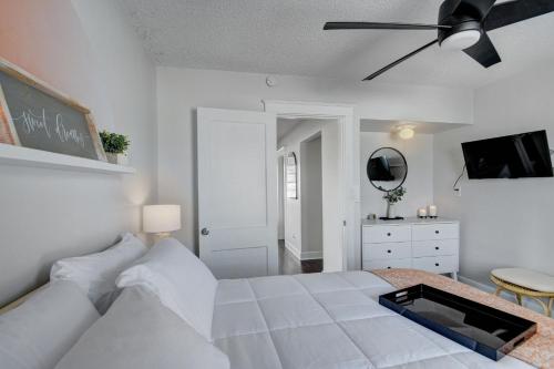 a white bedroom with a bed and a ceiling fan at Cozy 1-bd oasis Downtown Lake Worth, 5 Star Amenities in Lake Worth