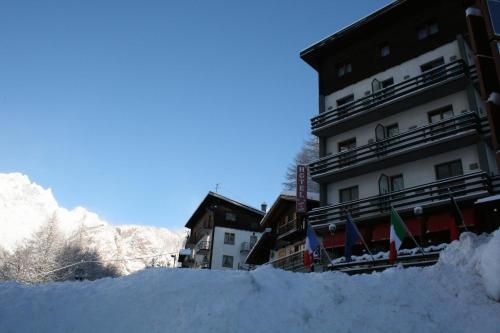 a pile of snow in front of a building at Hotel Etoile De Neige in Valtournenche