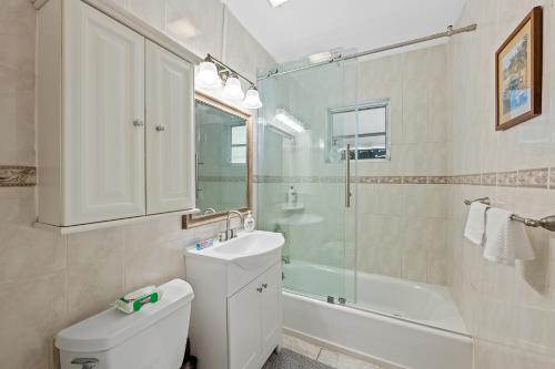 a bathroom with a toilet and a sink and a shower at Comfy BNB w/ King Bed + Work/Travel + Beach 8 Min in Hallandale Beach