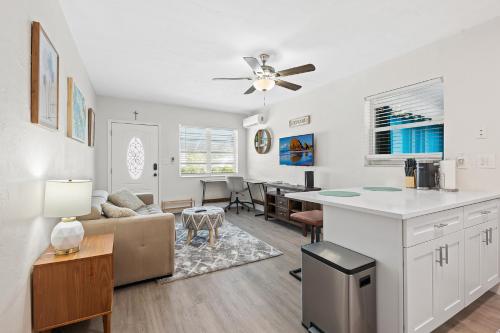 a kitchen and living room with a couch and a table at Comfy BNB w/ King Bed + Work/Travel + Beach 8 Min in Hallandale Beach