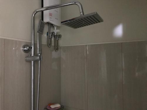 a shower with a shower head in a bathroom at Best Value Q Condo1439 in Manila