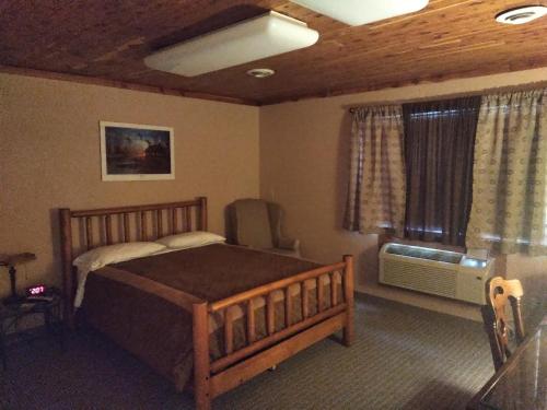 a bedroom with a large bed and a window at Comfort Zone Inn in Rothsay