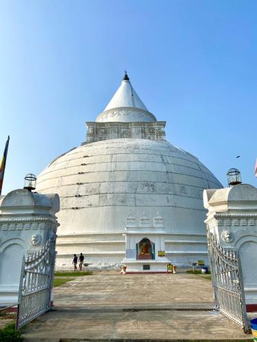 a large building with a gate in front of it at Wild Breeze in Tissamaharama