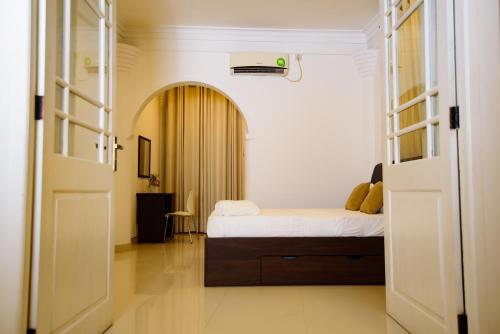a bedroom with a bed and an open door at Kandy view resort in Kandy