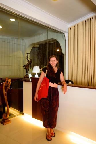 a woman standing next to a wall in a room at Kandy view resort in Kandy