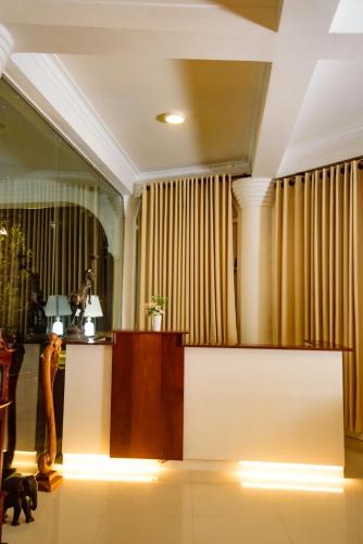 a lobby with a reception desk and curtains at Kandy view resort in Kandy
