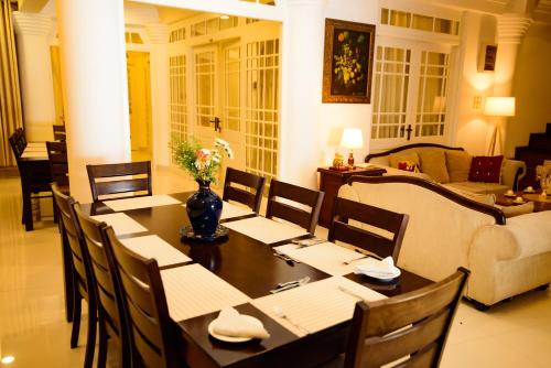 a dining room with a table and a couch at Kandy view resort in Kandy