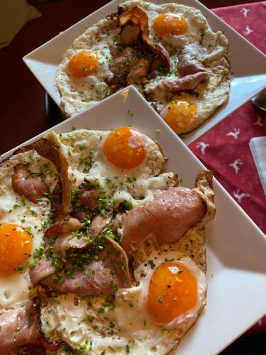 two slices of pizza with eggs on a plate at Gasthof Seelhofer in Prigglitz