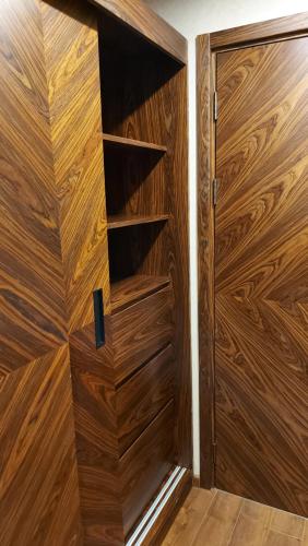 a wooden closet with a wooden door at Dreamland deluxe apartment in Chakvi