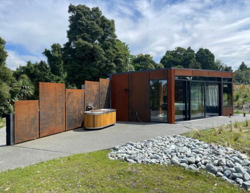 a modern house with a wooden facade at Ngā Whare Mānatu in Geraldine