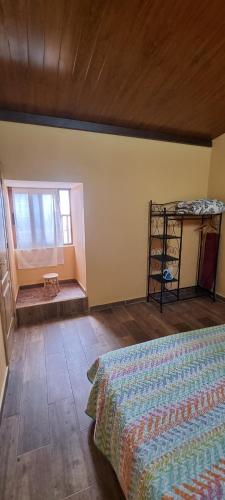a bedroom with a bed and a window and a shelf at Casa rural meridiano in El Pinar del Hierro