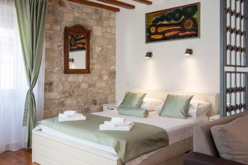 a bedroom with a bed with towels on it at Stephane City Vibe Suites in Trogir