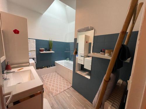 a bathroom with a sink and a bath tub at Lovely apartment in Périgueux in Périgueux