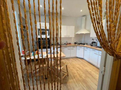 une cuisine avec des armoires blanches et une table dans l'établissement Lovely apartment in Périgueux, à Périgueux