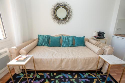 uma sala de estar com um sofá e um espelho em FABULOUS !!APARTMENT A FRONT OF LEGENDARY MONTE CARLO BEACH and TENNIS CLUB ! em Roquebrune-Cap-Martin