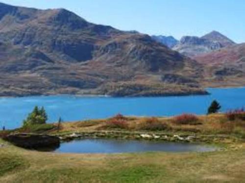 a view of a lake with mountains in the background at Chalet del paese Incantato comune di Moncenisio in Moncenisio