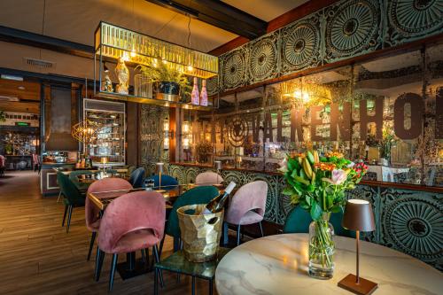 a restaurant with tables and chairs and a bar at Castle View 2 in Valkenburg