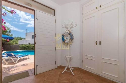 a room with a door leading to a pool at Villa ADELE Binibeca sea view in Binibeca