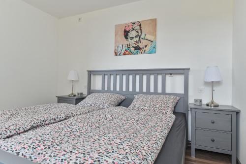 a bedroom with a bed and two night stands at Ruhige Ferienwohnung mit Panoramablick in Ingoldingen