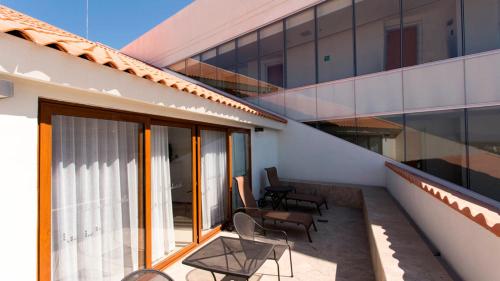 a balcony of a house with chairs and windows at Holiday Inn Express Puerto Vallarta by IHG in Puerto Vallarta