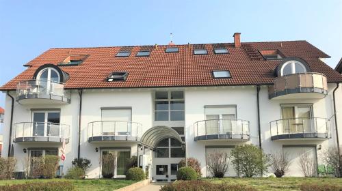 a large white building with a red roof at Fancy, EP Tickets über uns erhältlich in Rust