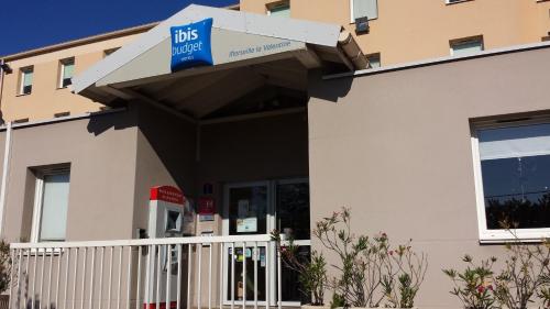 a building with a bus meter sign on it at Ibis Budget Marseille Valentine in Marseille