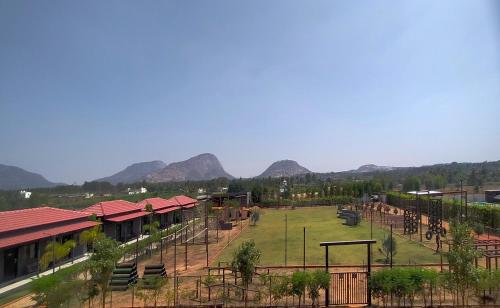 a view of a park with mountains in the background at VAMA Retreats in Bengaluru