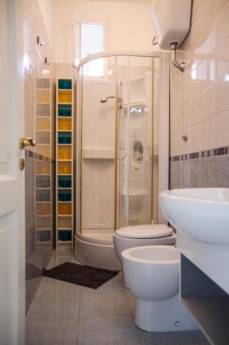 a bathroom with a toilet and a shower and a sink at Casa Colombo in Vietri sul Mare