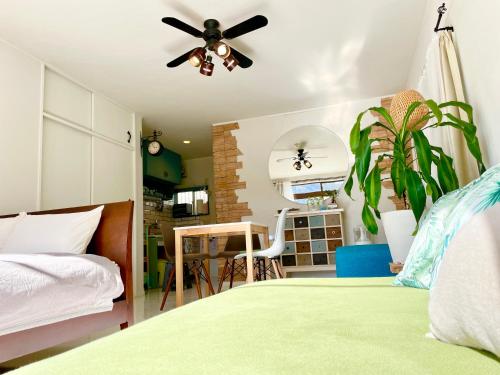 a bedroom with a bed and a ceiling fan at Kamakura Jomyoji Terrace-鎌倉浄明寺テラス- in Kamakura