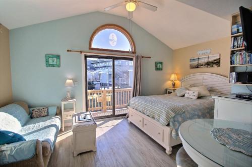 1 dormitorio con cama, sofá y ventana en 2 Cabana By The Sea Condo, en Hatteras