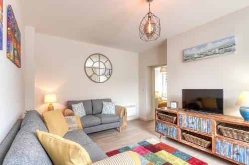 a living room with a couch and a tv at Ellinbrook Guest House in Hunstanton