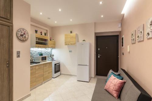 kuchnia z kanapą i lodówką w obiekcie Sirens Athens Apartment w Atenach