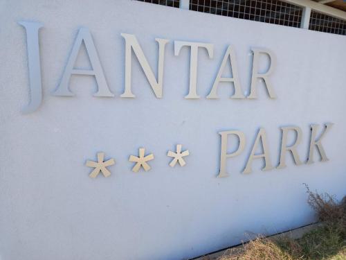 a sign for anantara park on the side of a building at Apartament Jantar Park in Jantar