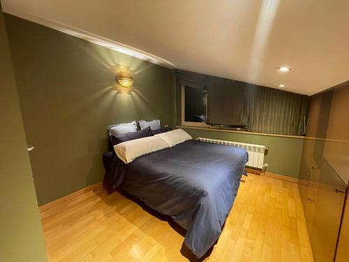 a bedroom with a bed and a light on the wall at Appartement chic au centre HUT 08087 in Escaldes-Engordany