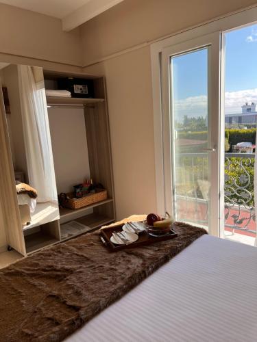 a bedroom with a bed and a large window at B. Equine Range Hotel in Narlıdere
