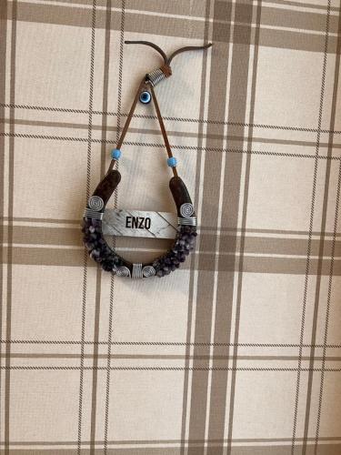 a beaded necklace hanging on a plaid shirt at B. Equine Range Hotel in Narlıdere