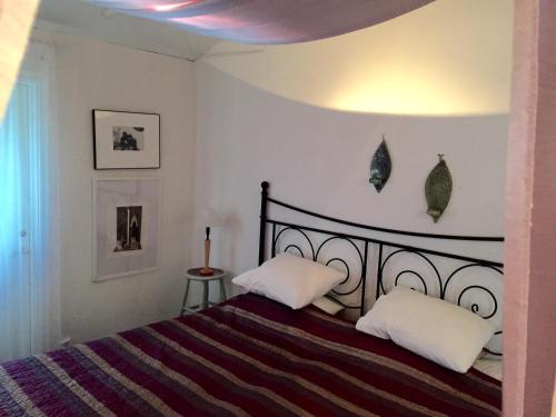a bedroom with a bed with two white pillows at Galleri huset studio in Blankaholm