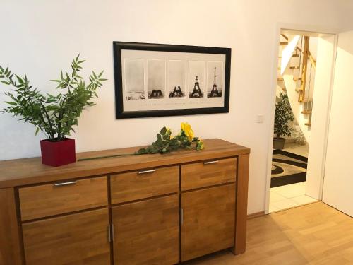 a wooden dresser in a room with a mirror at Stadtwohnung am Oertelplatz in Munich