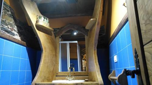 a bathroom with a wooden sink and a mirror at Casa Eladio 