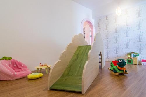 a childs play room with a slide in the middle of the room at Cest Mignon 包棟 溜滑梯 烤肉 麻將桌 夏日水池 in Dongshan