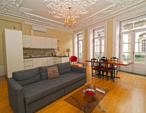 a living room with a couch and a table at São Domingos Flowers Apartments in Porto