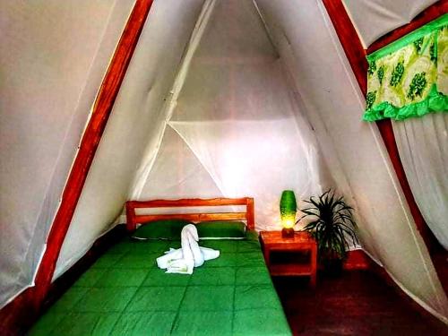 a room with a bed in a tent at SHUKRAN Apartelle in Siquijor