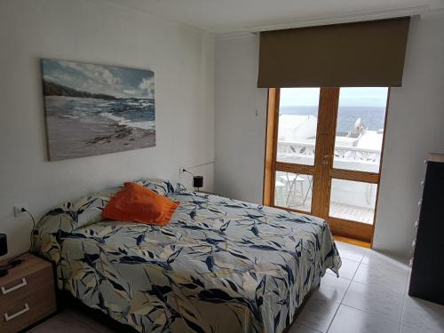 a bedroom with a bed and a view of the ocean at Morro Mar in Morro del Jable