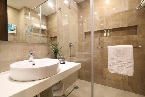 un baño con lavabo y ducha en Kwality's Motel Shiraz, en Bhopal