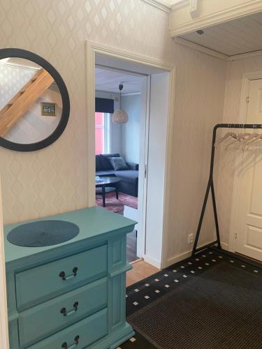 uma cómoda azul num quarto com um espelho em Gårdshuset mitt i centrala Gävle em Gävle