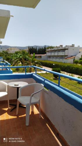 a balcony with a table and chairs on a roof at Giovanni Apartments Kos Studio 20 in Kos Town