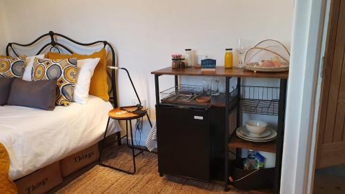 a bedroom with a bed and a night stand next to it at Kew Gardens - Private Double Room Richmond London - Homestay in Kew Gardens